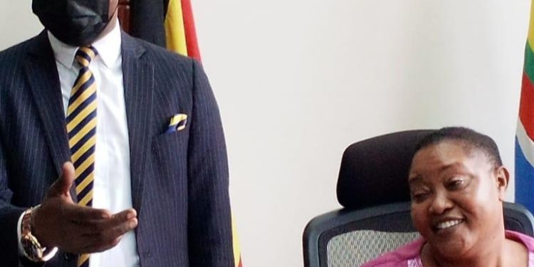 Joseph Ssewava with Minister Babalanda