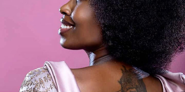 Bobi Wine's wife Barbie Kyagulanyi with a tattoo on her back