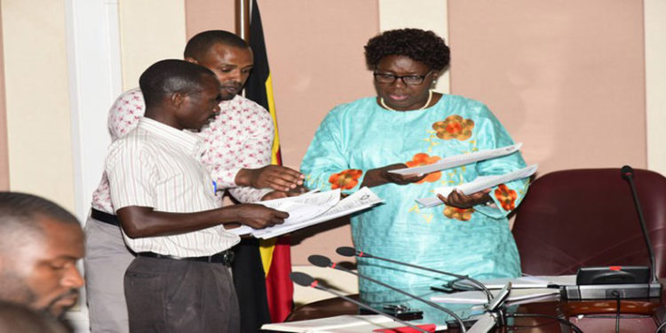 Speaker Kadaga (R) receives the petition