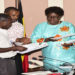 Speaker Kadaga (R) receives the petition