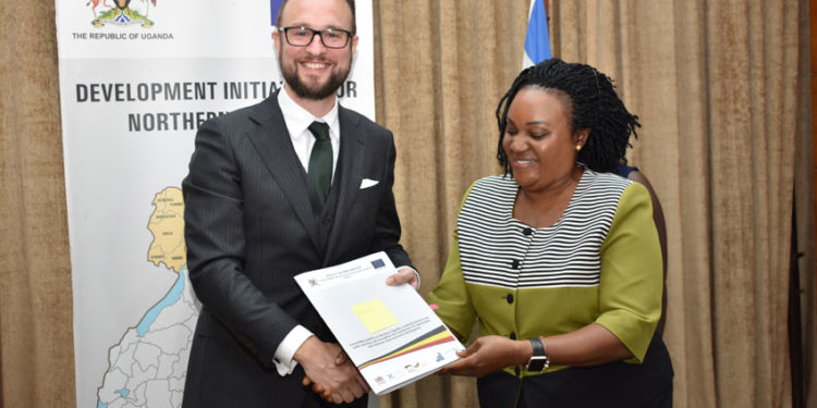 Ms Christine Guwatudde Kintu (Right), the Permanent Secretary at the Office of the Prime Minister (OPM), congratulates Mr Mathias Kamp, the country director of Konrad-Adenauer-Stiftung, one of the grantees shortly after signing the DINU grants contract at the OPM in Kampala on January 14, 2020.