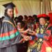 Prof. Ezra Suruma (Right) hands over the ACCA Uganda Award to Ms. Tumukunde Elizabeth, the best performing student in Bachelor of Commerce (Accounting Option) during the 2nd Session of the 69th Graduation Ceremony on 16th January 2019 at Makerere University, Kampala Uganda