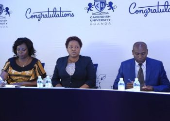 Cavendish University’s  Vice Chancellor Prof John Mugisha, and the Deputy Vice Chancellor, Dr. Olive Sabiiti (C) together with the Academic Registrar address the press