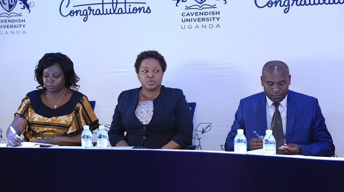 Cavendish University’s  Vice Chancellor Prof John Mugisha, and the Deputy Vice Chancellor, Dr. Olive Sabiiti (C) together with the Academic Registrar address the press