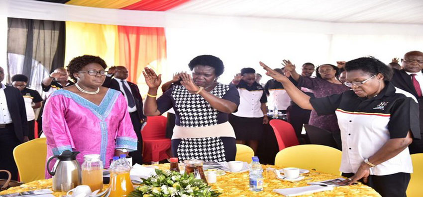 The Government Chief Whip, Hon Nankabirwa(C) and the Clerk to Parliament, Jane Kibirige(R) join other dignitaries in prayer for the Speaker(L)