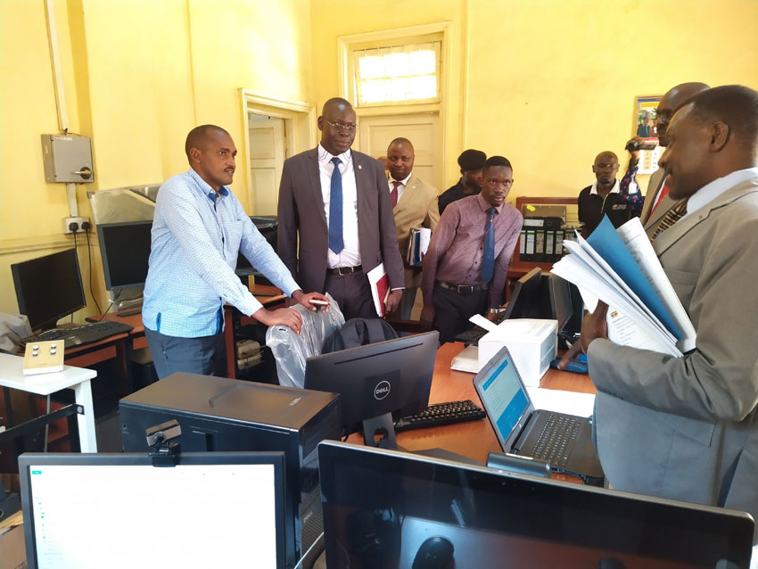 Gender Minister Frank Tumwebaze [L],  the Permanent Secretary James Ebitu[2L] during the inspection of the National Library in Kampala on Tuesday