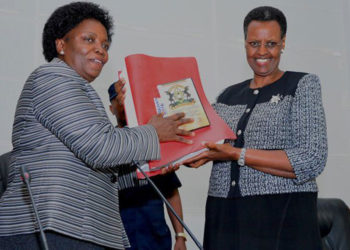 Education minister Janet Museveni (right) receives previous results from UNEB chairperson Mary Okwakol