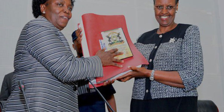 Education minister Janet Museveni (right) receives previous results from UNEB chairperson Mary Okwakol