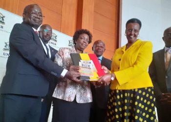 UNEB Executive Secretary Dan Odongo (L) , board chair Mary Okwakol (m) handing over the 2019 UACE results to education and sports minister Janet Museveni