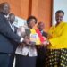 UNEB Executive Secretary Dan Odongo (L) , board chair Mary Okwakol (m) handing over the 2019 UACE results to education and sports minister Janet Museveni