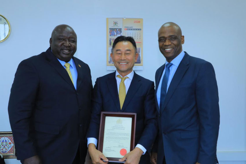 Minister of state in charge of International Affairs Mr Henry Okello Oryem with Mr Lee Sung [middle]