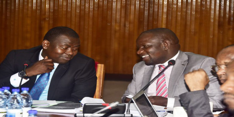 Cosase Vice Chair, Hon Kasozi(L) with Hon Paul Mwiru during the committee sitting