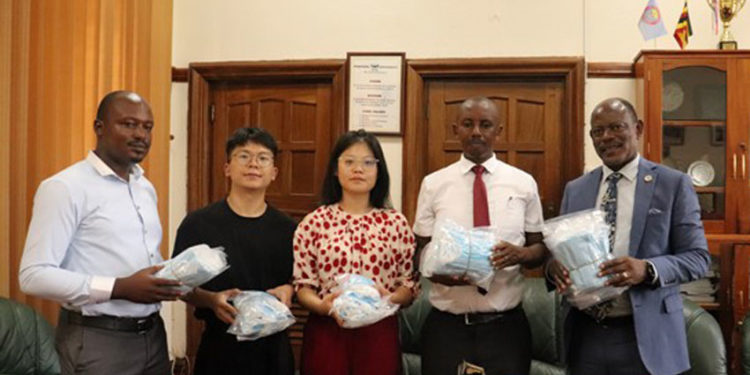 Prof Nawangwe handing over the surgical masks to Xiangtan University officials on Tuesday. PHOTO: Campus Bee