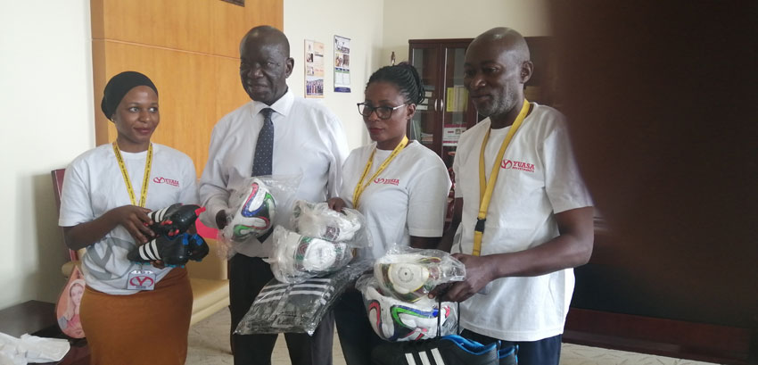 Yuasa officials handing over sports equipment to the Vice President