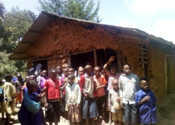 Some of the pupils infront of one of the ramshackle structures at Murungu Primary School