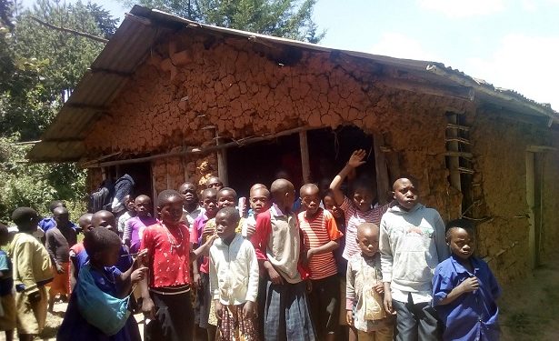 Some of the pupils infront of one of the ramshackle structures at Murungu Primary School