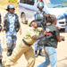 A police officer manhandling a journalist