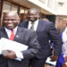 FDC's Wafula Oguttu(L) with the Party President, Hon Amuriat (C) after appearing before the Committee with LOP, Hon Aol Ocan