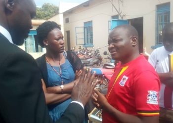 Arrested journalist James Odongo Akia (in red)