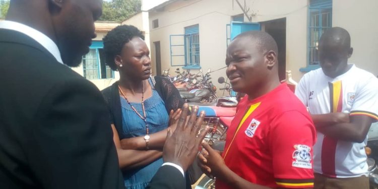 Arrested journalist James Odongo Akia (in red)