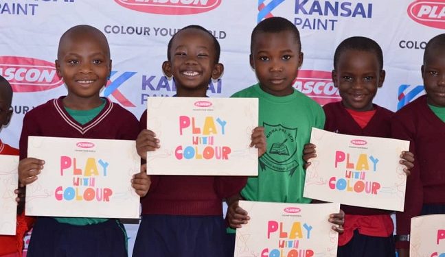 Pupils at Kiswa Primary School display the newly launched colour books