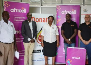 Uganda Blood Transfusion Services (UBTS) Public relations officer Mr Michael Mukundane (left), and UBTS executive director Dr Dorothy Nakyeyune (centre), pose for the photo with the Africell IT manager Mr Innocent Mbiro (2nd left), Public relations officer Edgar Karamagi (2rd right) and marketing manager Marc Aad (extreme right).