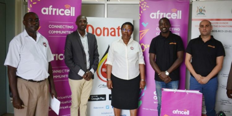 Uganda Blood Transfusion Services (UBTS) Public relations officer Mr Michael Mukundane (left), and UBTS executive director Dr Dorothy Nakyeyune (centre), pose for the photo with the Africell IT manager Mr Innocent Mbiro (2nd left), Public relations officer Edgar Karamagi (2rd right) and marketing manager Marc Aad (extreme right).