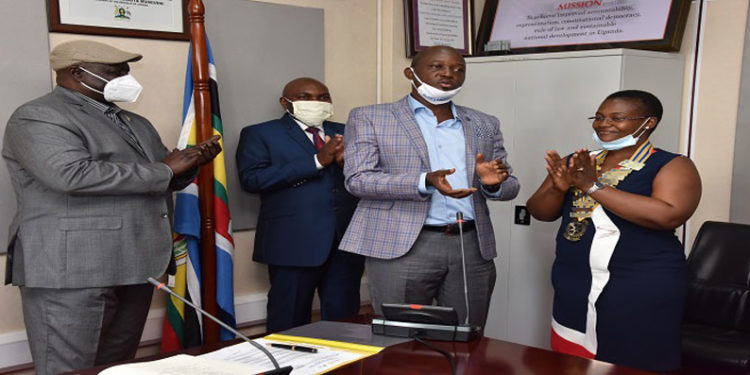 Deputy Speaker, Jacob Oulanyah (left) presides over the installation of Sheila Naturinda (right) as President of the Rotary Club of Kampala Central. PDG Ken Mugisha installed Naturinda. (2nd left) is Charles Lwanga Kiiza, the outgoing President of the Club