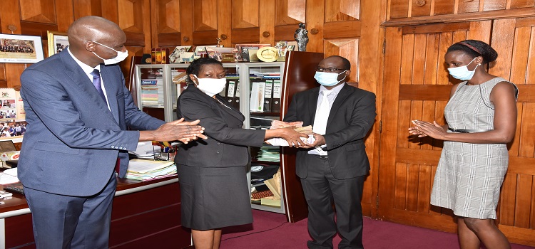 Clerk to Parliament, Ms Jane Kibirige (2nd L) handsover Shs30 million to Dr. Samuel Guma, the Executive Director at New Hope Children’s Hostel. (Left) is the Deputy Clerk to Parliament, Mr. Henry Waiswa (left) and (right) is Henrieta Kebirungi, Resource Mobiliser of New Hope Children’s Hostel