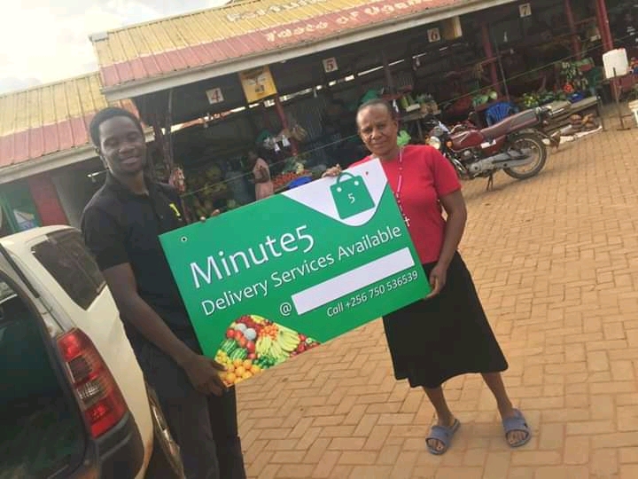 A Minute 5 team member poses with a newly signed up market vendor as part of their campaign to have greater reach