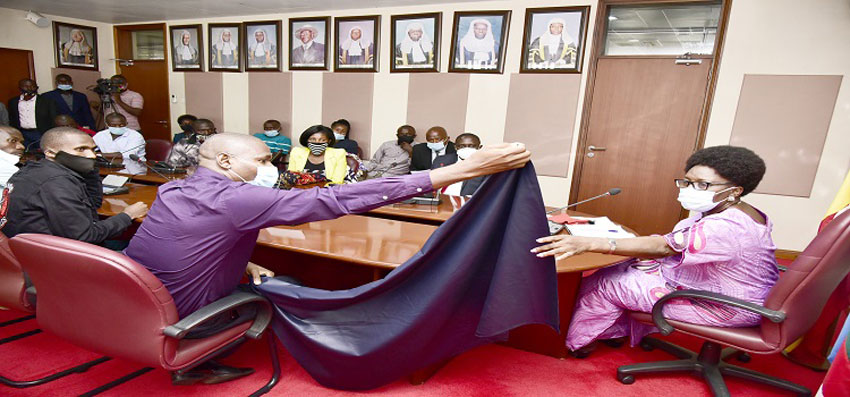 An importer displays material used to make men’s clothes as textile traders petitioned the Speaker (right) on Friday, 24 July 2020