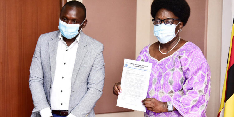 Speaker Kadaga receiving the petition from Abdu Karim Mucunguzi, the association's chairperson.