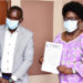 Speaker Kadaga receiving the petition from Abdu Karim Mucunguzi, the association's chairperson.