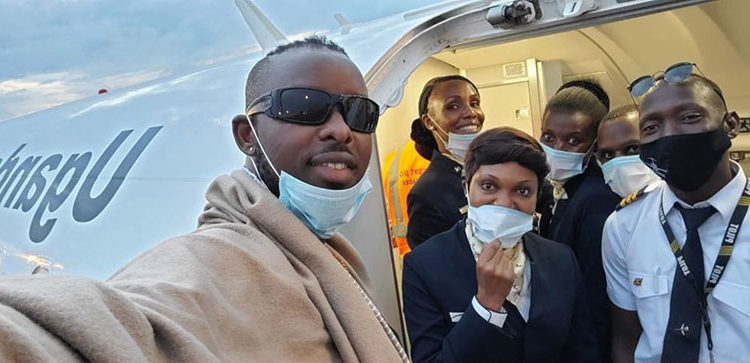 Eddy Kenzo with Uganda Airlines cabin crew on Friday