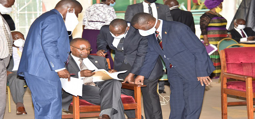 MPs surround the Local Govt minister after he presented the motion on the creation of new counties