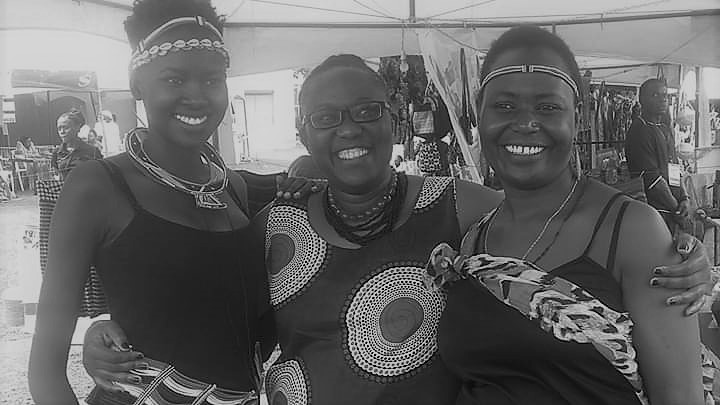 Atesot in the centre with two Karimojong beauties during a cultural festival