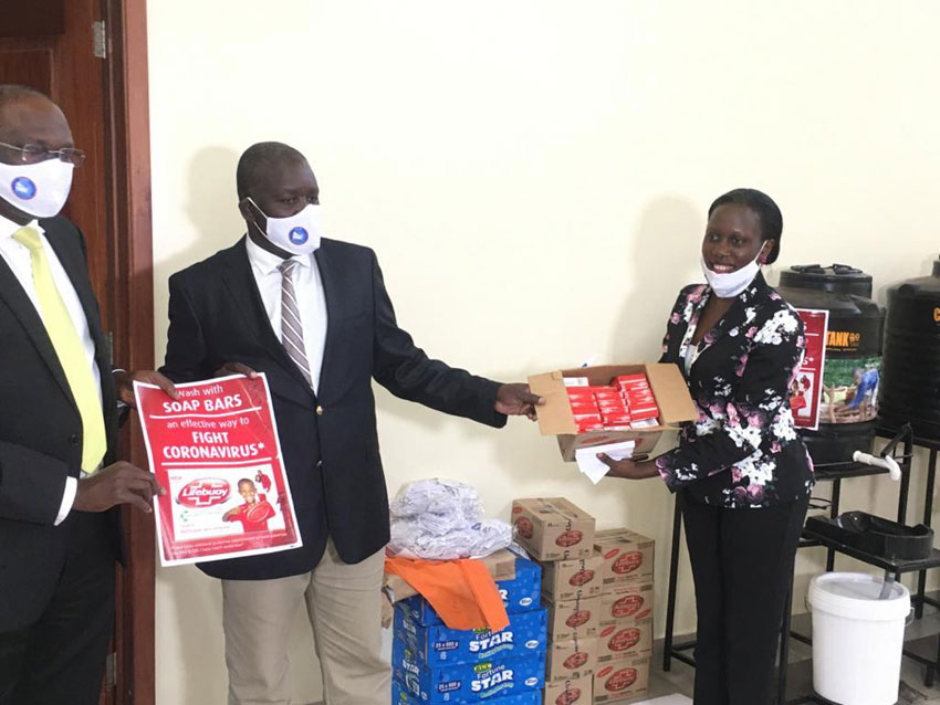 The Permanent Secretary-Minister of Water and Environment, Alfred Okot Okidi receiving items from Unilever on Tuesday at the Ministry's offices in Kampala