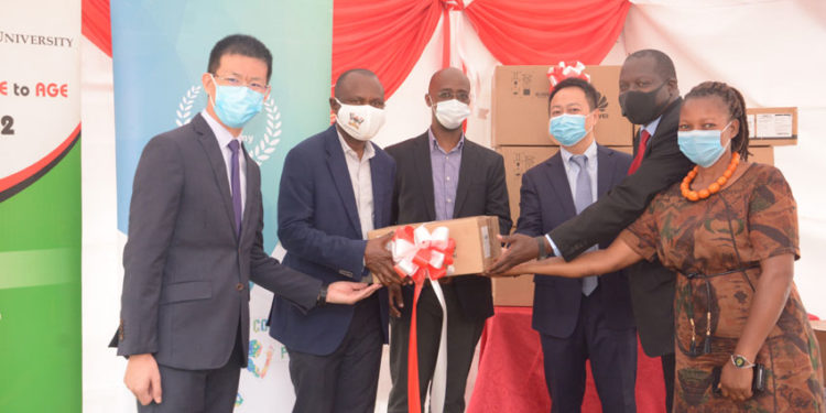Huawei officials handing over ICT study equipment to Makerere University on Friday