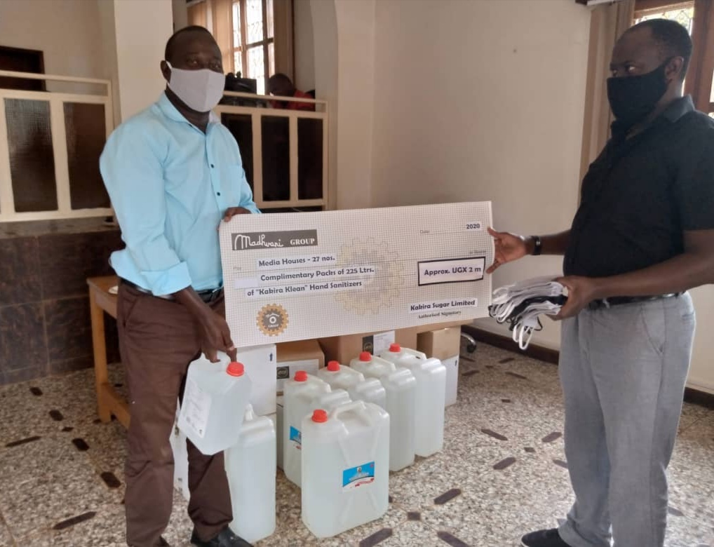 Mike Ssegawa receives masks and sanitizers on behalf of Watcdog News from Mr Ismail Sentamu, Program Officer, Learning and Strategy atbTwaweza East Africa as part of a donation from Twaweza and Madhvani Group to the media fraternity.