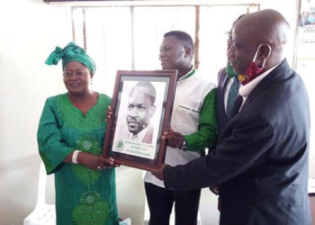 MP Mary Kabanda receiving her accolade from DP president Norbert Mao