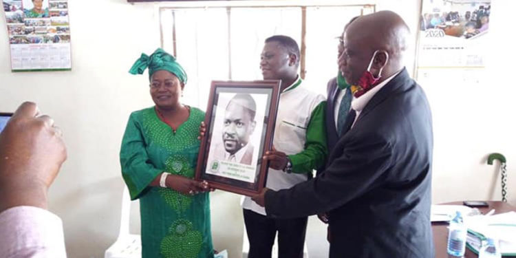 MP Mary Kabanda receiving her accolade from DP president Norbert Mao