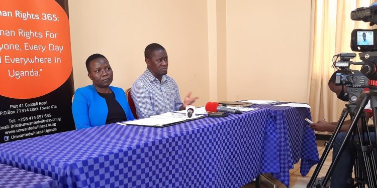 Unwanted Witness's boss Dorothy Mukasa and organization's head of legal department Allan Sempala Kigozi addressing the media on Tuesday