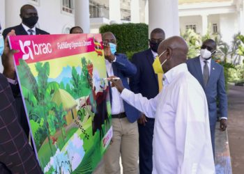 President Yoweri Kaguta Museveni signs on one of the placards on the Brac Uganda Bank Limited as the country Director George Owuor Matete and the CEO Jimmy Onesmus Adiga look on shortly after their meeting at State House in Entebbe on 2nd September 2020.