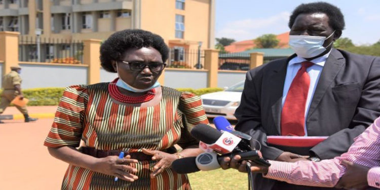 MPs Cecilia Ogwal (L) and Charles Angiro Abacacon addressing journalists after attending Police Disciplinary Court in Naguru, Kampala