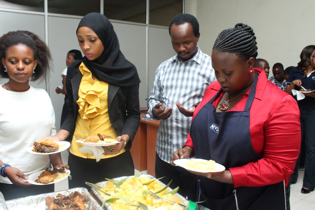 Business Man Chris Mutinye and his employees at a work dinner before the forceful closure of his company.