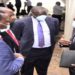 Attorney General William Byaruhanga (R) engaging MPs after a session