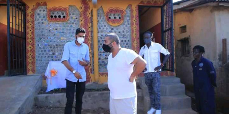 Rajiv Ruparelia inspects one of the eco toilets in Kamwokya