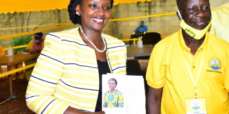 Musherure stands alongside NRM Electoral Commission boss Tanga Odoi