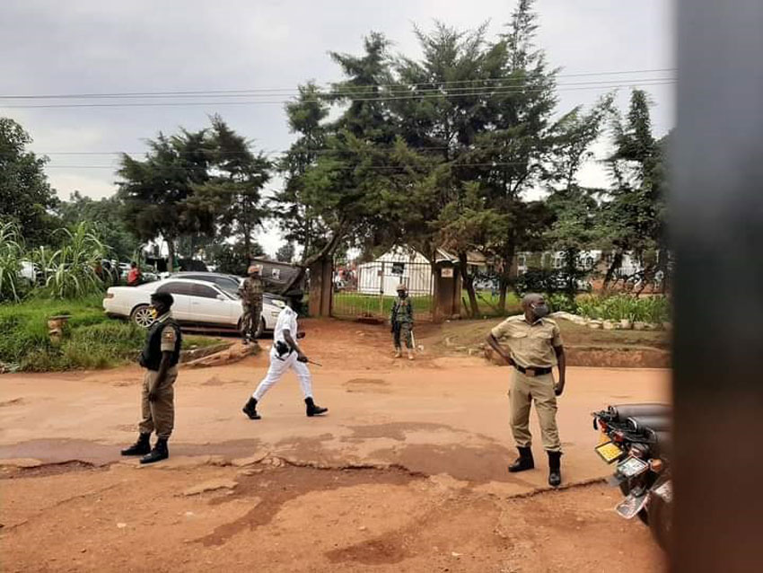 Police officers standing on the way to NUP offices in Kamwokya