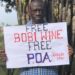 Dr Besigye with a #FreeBobiWine placard